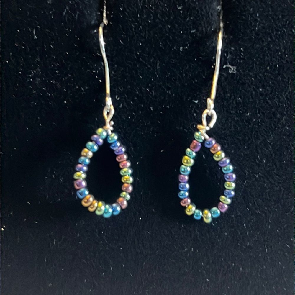 Handcrafted silver tone and multicolored bead earrings.